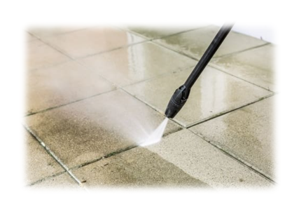 A person using a power washer on the floor.